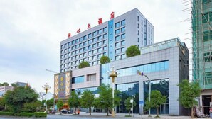 A multi-story hotel with a modern facade, large windows, and a prominent entrance. - Tongxin Hotel (Zhenfeng)