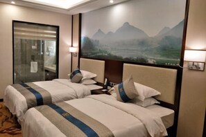 A hotel room with two beds, a glass door, and a large wall mural of a mountainous landscape. - Tongxin Hotel (Zhenfeng)