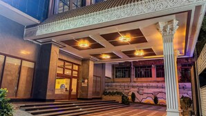 A hotel entrance with a grand staircase, a reception desk, and a decorative overhang. - Zip By Spree Hotels Surabi International Vellore (Vellore)