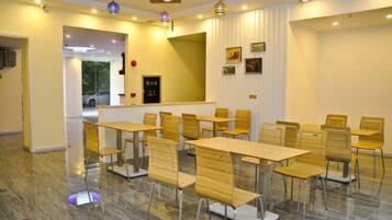 A conference room with tables and chairs arranged for meetings.