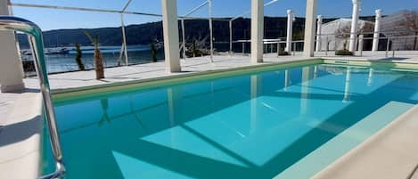Apartment (One Bedroom apartment with sea view) | Pool | Seasonal outdoor pool, pool umbrellas, sun loungers