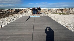 A wooden pier leading to a rocky shoreline with a clear sky. - 6 Sleeper self catering house (L'Agulhas)