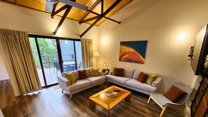 A living room with a sectional sofa, a coffee table, and a TV.