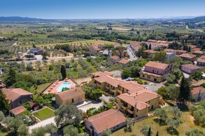 A residential area with multiple two-story buildings, a swimming pool, and surrounding greenery. - Apartment 'Bilocale Ansonica' with Balcony, Shared Pool & Wi-Fi (Suvereto)