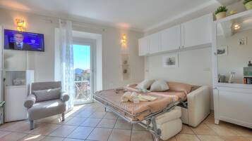 Standard Studio, Lake View (Nido Belvedere AC and Lake View) | Living area | 21-inch flat-screen TV with digital channels, TV