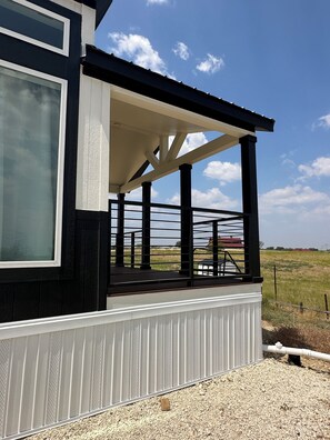 A building with a covered porch and a large window.
