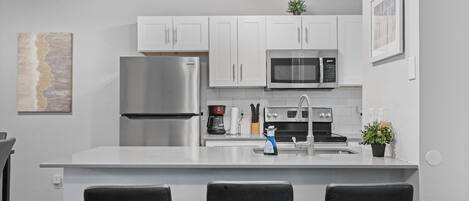 Enjoy cooking in this well-equipped kitchen with an oven, microwave, and stainless steel appliances.