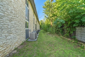 Stroll through this serene courtyard surrounded by lush greenery and enjoy the cool, shaded atmosphere.