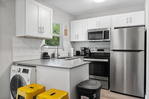 Enjoy cooking in this well-equipped kitchen with a large island, sink, and appliances.