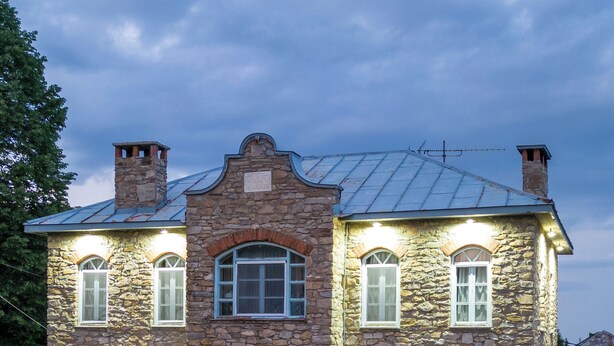 A stone building with a central entrance, a hot tub, and a well-maintained garden. - Dandy Villas Nymfaio Snowfairy (Amyntaio)