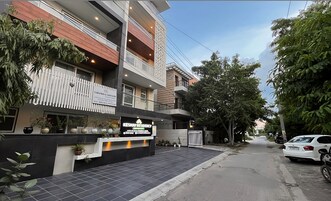 A modern building with a sign for 'Keshav Residency' and 'Ushanker & Associates'.