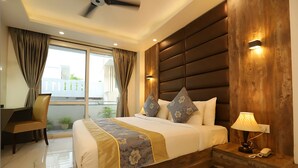 A modern hotel room with a large bed, a desk, and a view of the outdoors. - Hotel Keshav Residency - Medicity Gurugram, near Medanta Hospital (Gurugram)
