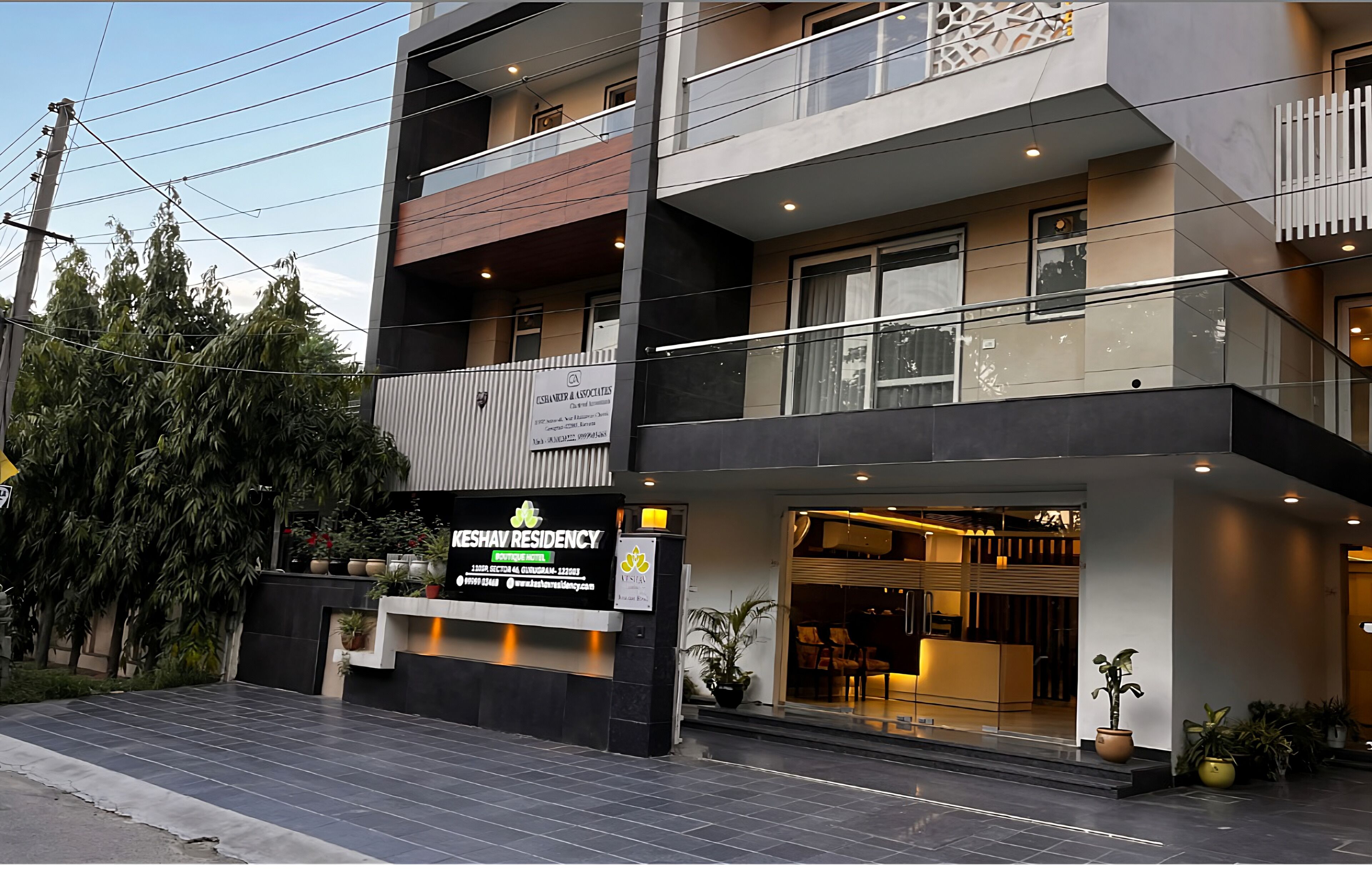 A modern building with a reception area, multiple floors, and a balcony.