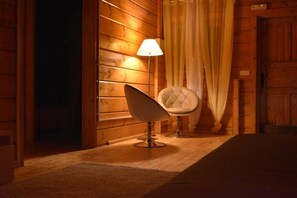 A wooden interior with a modern chair and a lamp.