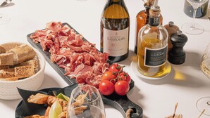 A table set with various food items, wine bottles, and glasses, suggesting a dining experience. - Les Villas du Château de Lastours (Portel-des-Corbières)