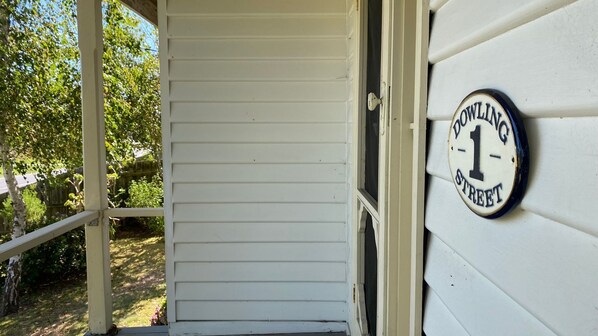 A white house with a porch and a sign that reads "Dowling 1 Street". - EDWARDIAN GETAWAY - Wonthaggi (Wonthaggi)