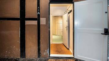 A hallway with a white door and a brown wall.