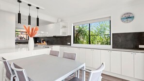Enjoy cooking in this well-equipped kitchen with a central island and ample natural light.