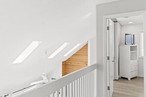 A modern interior with a staircase, a white wall, and a wooden floor. - 4 bdrm, Beach Front, Sun-Sun Pet Friendly (Cape San Blas)