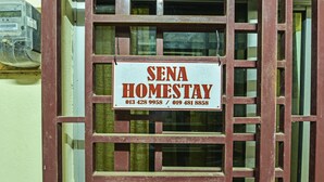 A sign for 'SENA HOMESTAY' with contact numbers. - OYO Home 90492 Sena Homestay (Pokok Sena)