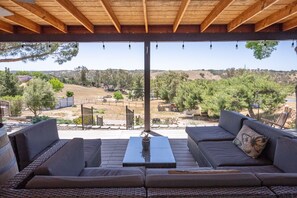 A covered outdoor seating area with a view of a rural landscape. - Spa + Firepit + BBQ | Eastside Paso Wine Country | Casa Robles (Paso Robles)