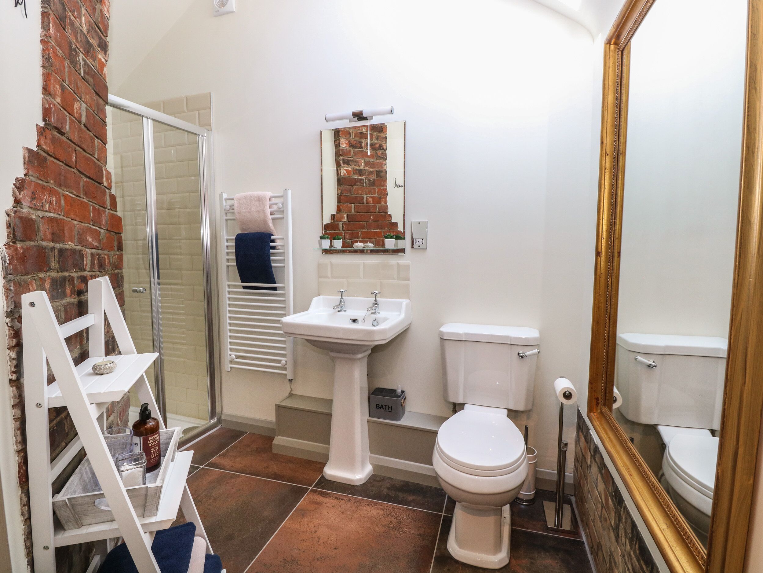 A bathroom with a white sink, a toilet, and a shower area.