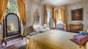 A luxurious bedroom with ornate furniture, a large bed, a mirror, and a painting. - VILLA CONTE - Seven Bedroom Villa, Sleeps 14 (Lucca)