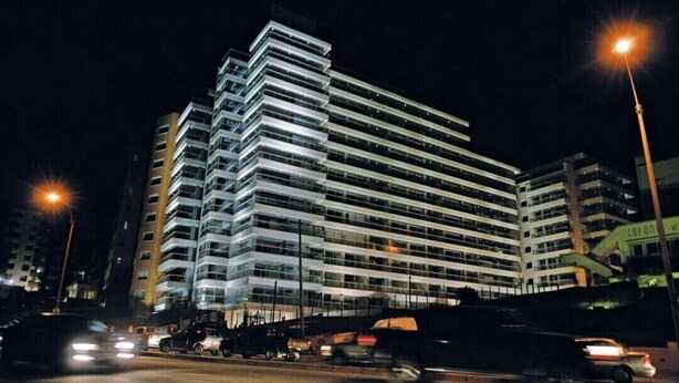 A multi-story building with a modern architectural design, featuring a series of balconies and large windows. - Modern, cosy and practical place (Montevideo)