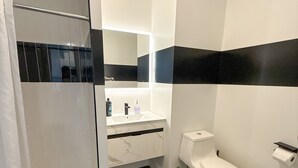 A modern bathroom with a shower, toilet, and sink. - 2BR apt close to EWR Airport m5og (Elizabeth)