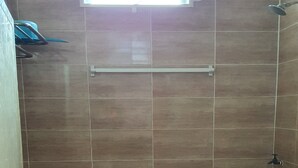 A small bathroom with a toilet, a sink, and a window. - OYO Home 90496 Delima Homestay (Alor Setar)
