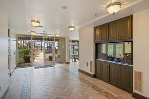 Experience the hotel's modern lobby, featuring a herringbone-patterned floor and a stunning aquarium.