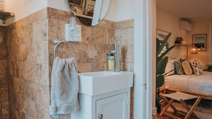 A bathroom with a sink, mirror, and towel rack. - Willow Pond Motel (Catskill)