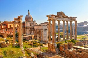 Ancient ruins with columns and a large dome structure.