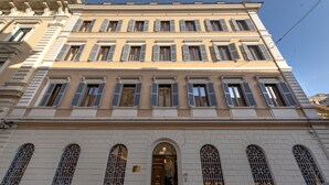 A multi-story building with a classical architectural style, featuring arched windows and a central entrance. - Sentho Roma (Rome)
