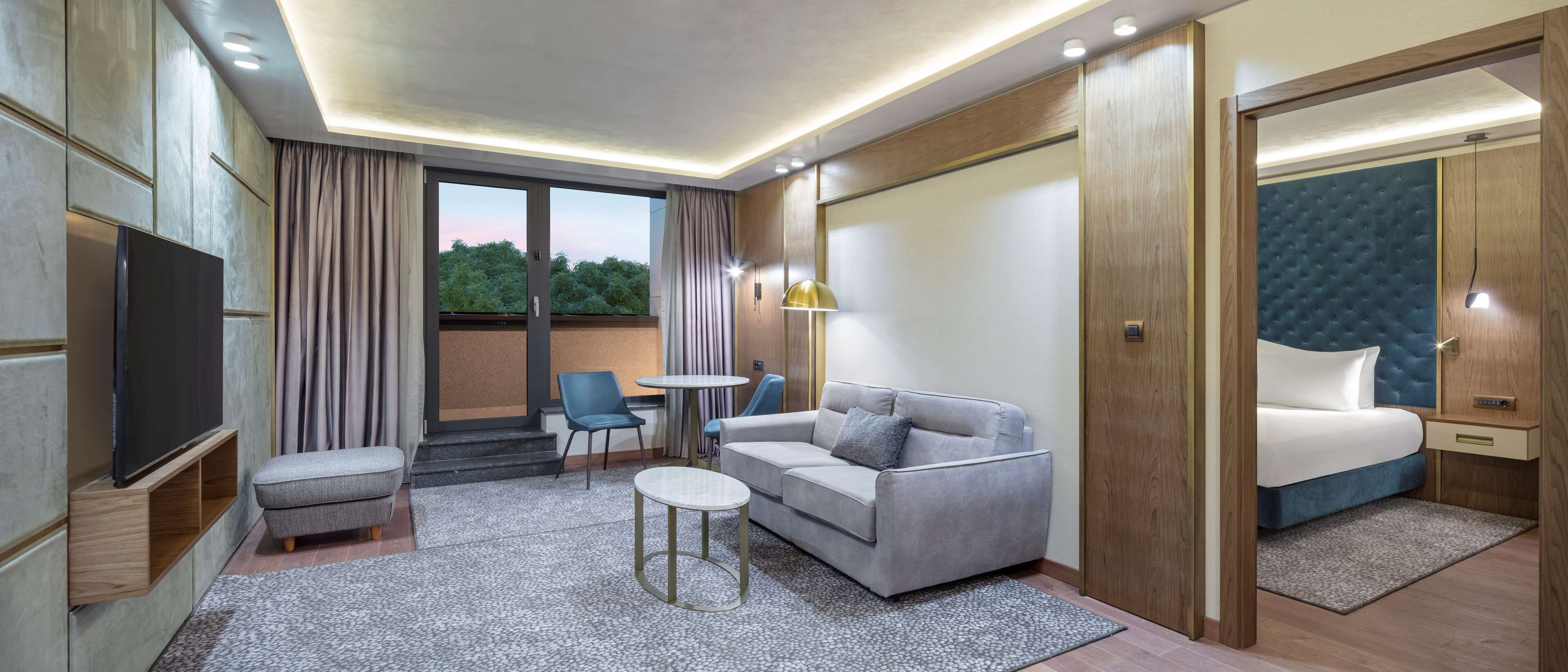 king one bedroom suite | living area | 55-inch flat-screen tv with cable channels, tv