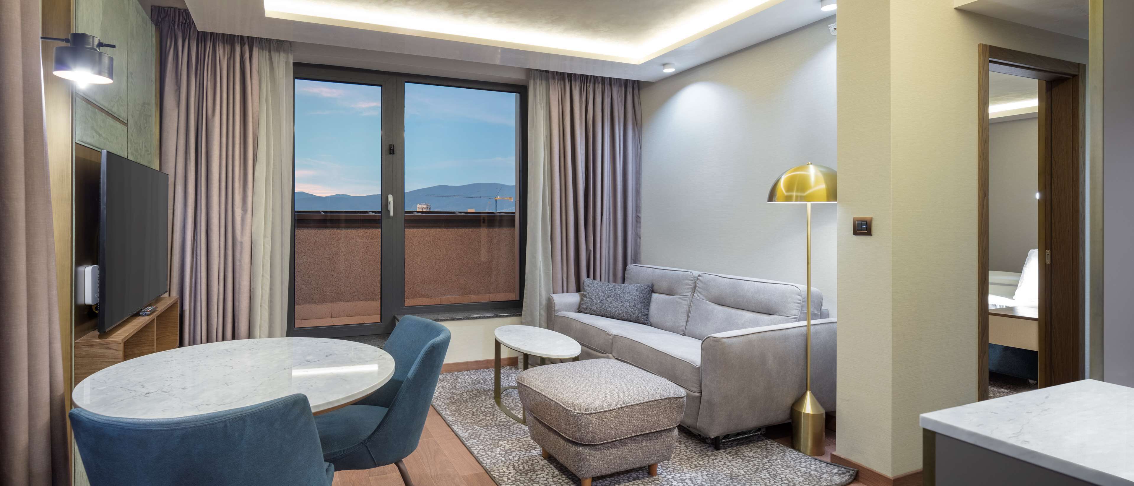 king two bedroom suite | living area | 55-inch flat-screen tv with cable channels, tv