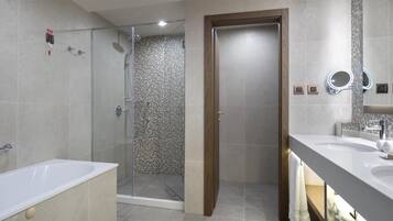A modern bathroom with a bathtub, a shower enclosure, and a vanity with a mirror.