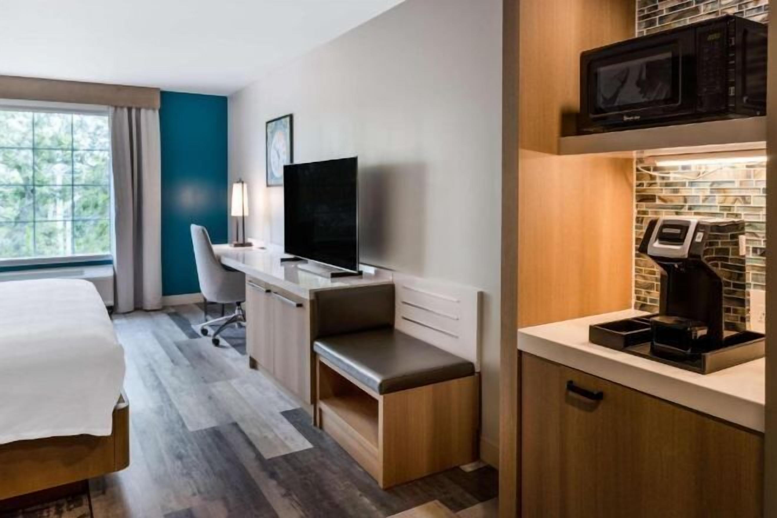 Desk, laptop workspace, iron/ironing board, bed sheets