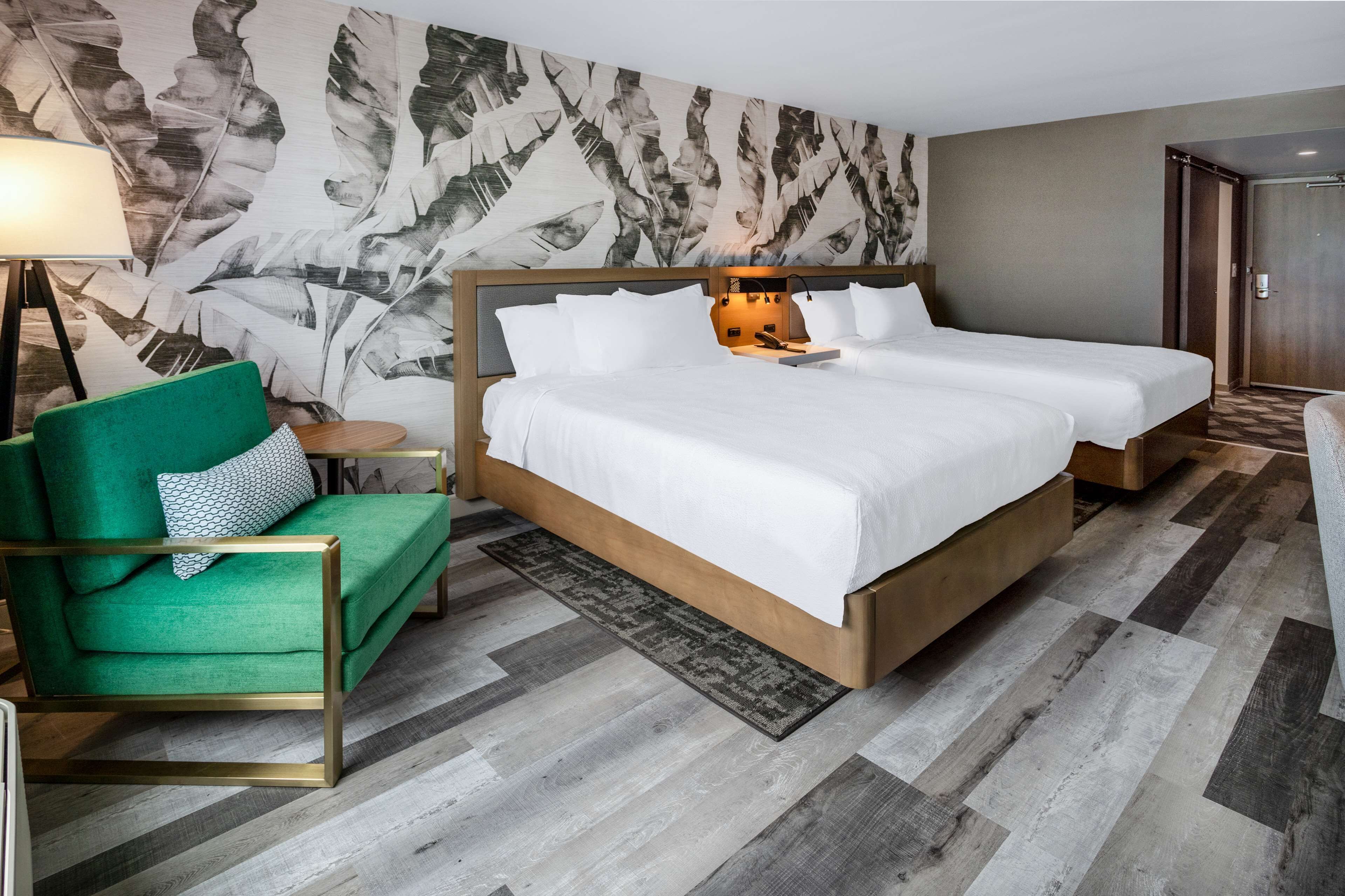 desk, laptop workspace, iron/ironing board, bed sheets