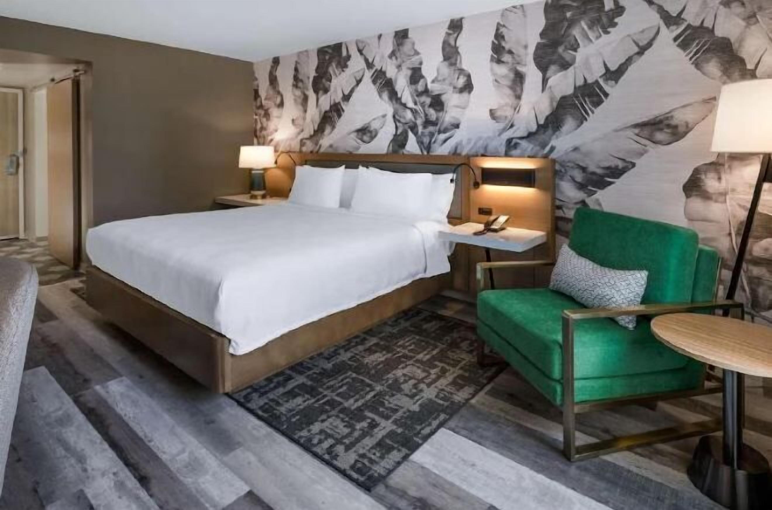 Desk, laptop workspace, iron/ironing board, bed sheets