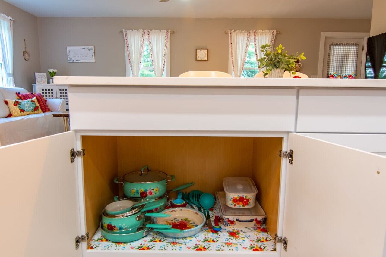 A compact kitchen with white cabinets and a small countertop.