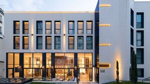 A modern hotel with a spacious lobby, large windows, and a well-lit entrance. - Hotel Yac Paris Clichy, A Member Of Radisson Individuals (Clichy)