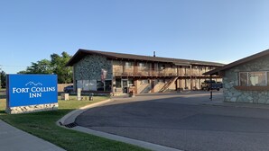 A building with a stone facade and a sign reading "Fort Collins Inn". - Fort Collins Inn (Fort Collins)