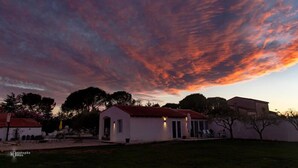 A white building with a red roof, surrounded by trees and a grassy area. - Croissant de Lune (Bagard)