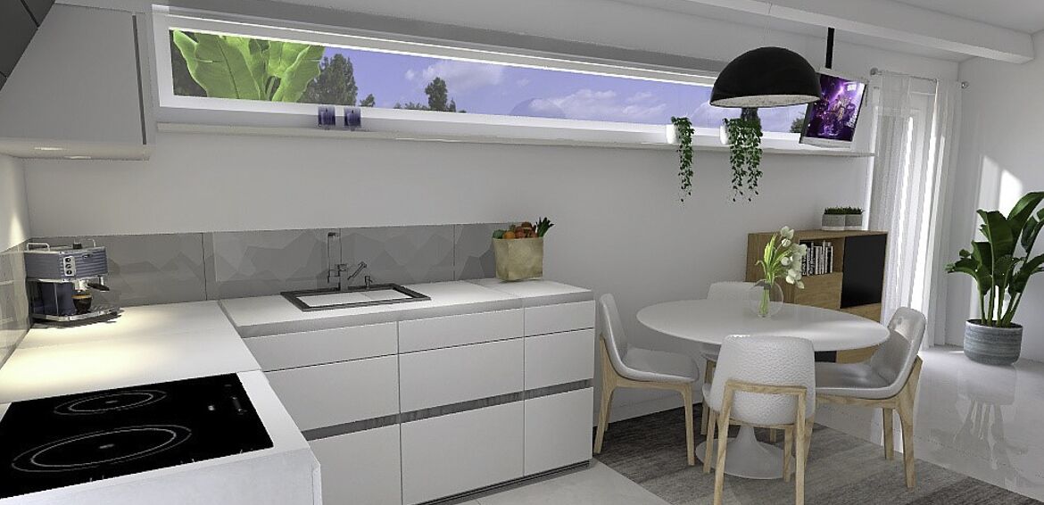 Una cocina moderna con comedor, electrodomésticos integrados y un amplio ventanal con vistas.