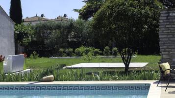 Alberca al aire libre y camastros