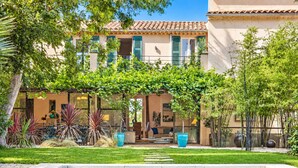 A poolside view of a building with a covered patio, outdoor seating, and a swimming pool. - ☀️La plage☀️<br>Classified ⭐️⭐️⭐️⭐️ (Antibes)
