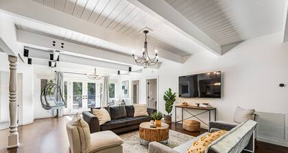 Stunning lakehouse lodge with a deck, fireplace, lush patio & lake access