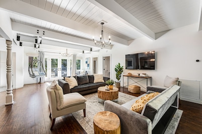 Stunning lakehouse lodge with a deck, fireplace, lush patio & lake access