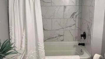 Combined shower/bathtub, hair dryer, towels, toilet paper